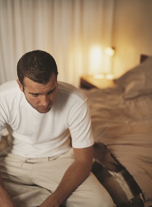 man sitting on bed